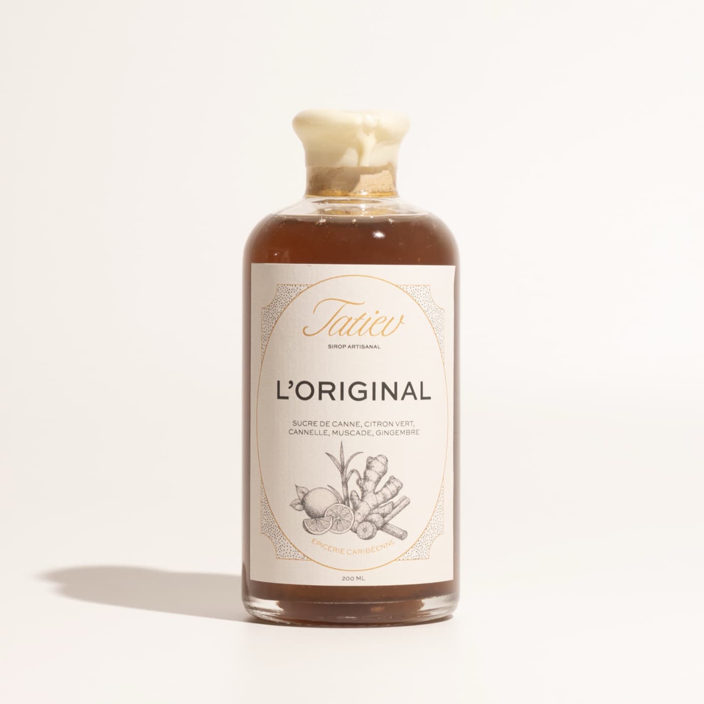 Bouteille de sirop L'Original sur fond crème
